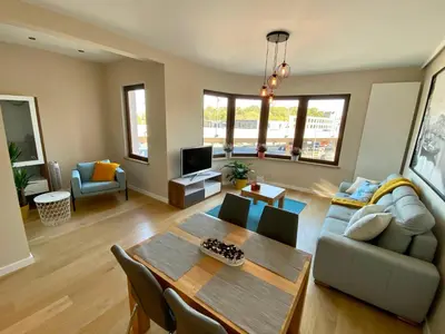 a living room with a table and a couch at Appartements Gustav in Brussels