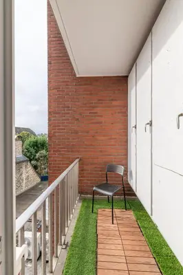 a bench sitting on a balcony with grass at VilvoCity Center in Vilvoorde
