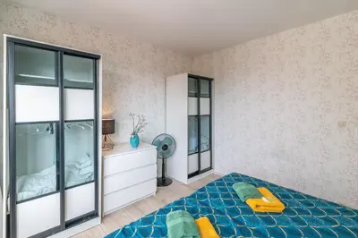a bedroom with a large bed and a mirror at VilvoCity Center in Vilvoorde