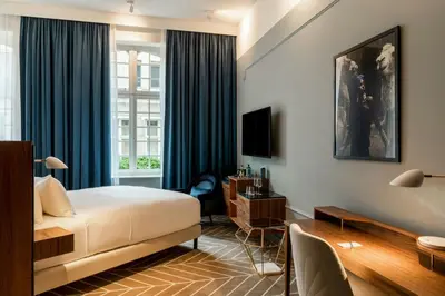 a hotel room with a bed and a window at Sapphire House Antwerp, Autograph Collection in Antwerp