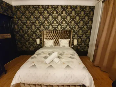 a bedroom with a large bed with white sheets at Brussels 1904 in Brussels