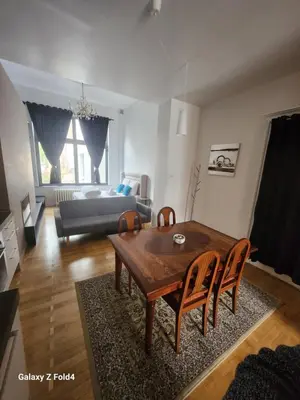 a living room with a table and chairs and a couch at Brussels 1904 in Brussels