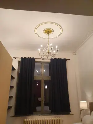 a room with a chandelier and a window at Brussels 1904 in Brussels