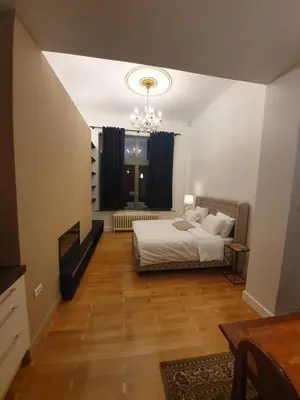a bedroom with a bed and a chandelier at Brussels 1904 in Brussels