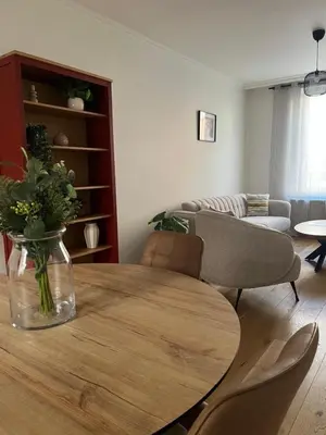 a living room with a table and a couch at FDS Cosy House in Ghent