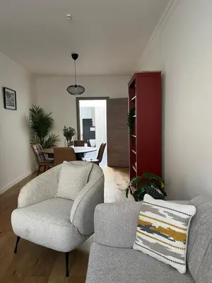 a living room with a couch and a chair at FDS Cosy House in Ghent