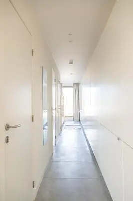 an empty hallway with white walls and a door at Trendy Apartments as Base to Discover Ghent in Ghent