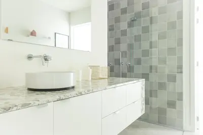 a white bathroom with a sink and a mirror at Trendy Apartments as Base to Discover Ghent in Ghent