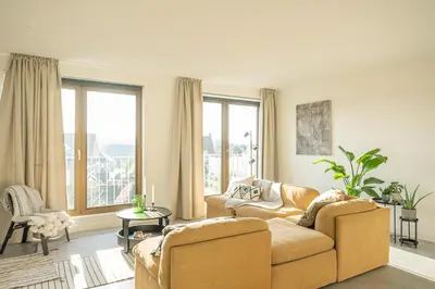 a living room with two couches and a large window at Trendy Apartments as Base to Discover Ghent in Ghent