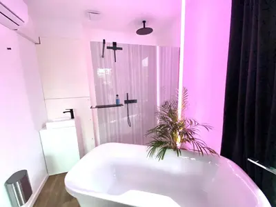 a bathroom with a white tub and a shower at The Square - vacation rental with outdoor sauna - centre of Antwerp in Antwerp