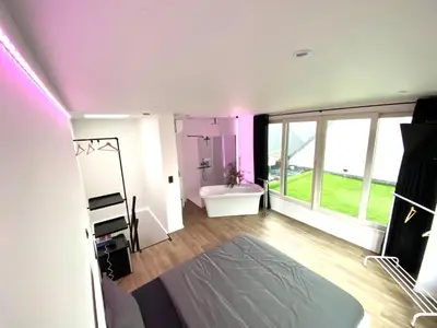 a room with a bedroom with a tub and a sink at The Square - vacation rental with outdoor sauna - centre of Antwerp in Antwerp