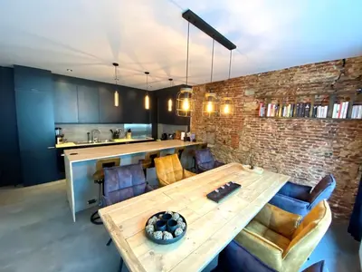 a living room with a wooden table and chairs at The Square - vacation rental with outdoor sauna - centre of Antwerp in Antwerp