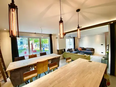 a living room with a table and a couch at The Square - vacation rental with outdoor sauna - centre of Antwerp in Antwerp