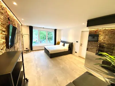 a bedroom with a bed and a large window at The Square - vacation rental with outdoor sauna - centre of Antwerp in Antwerp