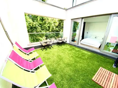 a patio with chairs and a yard with grass at The Square - vacation rental with outdoor sauna - centre of Antwerp in Antwerp