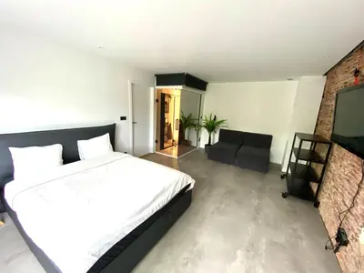 a bedroom with a bed and a living room at The Square - vacation rental with outdoor sauna - centre of Antwerp in Antwerp