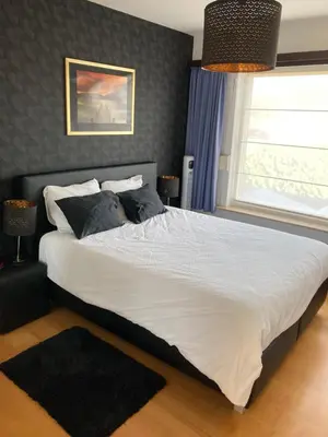 a bedroom with a large white bed with a window at Crea Els in Westerlo