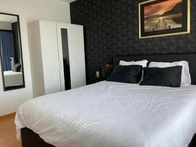 a bedroom with a large white bed with black pillows at Crea Els in Westerlo