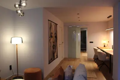 a living room with a couch and a table at Maison Drappier in Ghent