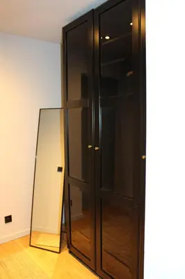 a large black cabinet with a mirror next to it at Maison Drappier in Ghent
