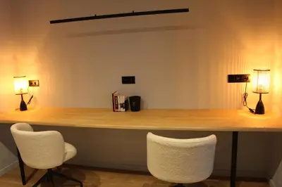 a counter with two chairs and two lamps on it at Maison Drappier in Ghent