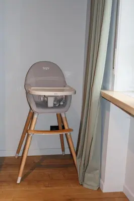 a high chair sitting on a stool next to a curtain at Maison Drappier in Ghent