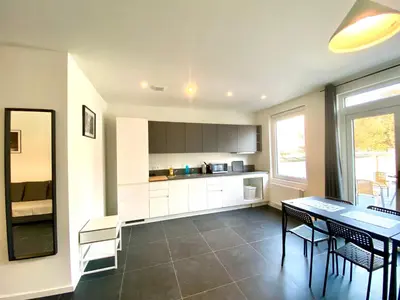 a kitchen with a table and chairs and a dining room at Isabel Apartments in Antwerp