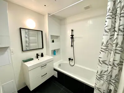 a white bathroom with a sink and a shower at Isabel Apartments in Antwerp