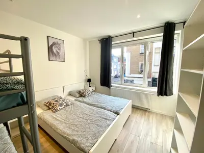 a bedroom with two beds and a window at Isabel Apartments in Antwerp