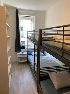a room with three bunk beds and a window at Isabel Apartments in Antwerp