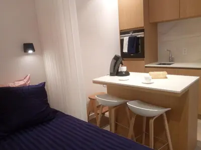 a bedroom with a bed and a kitchen with a counter at STUDIO61 in Ghent