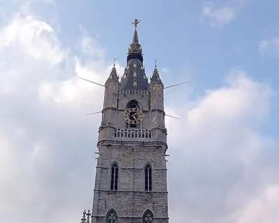 a clock tower with a bird on top of it at STUDIO61 in Ghent