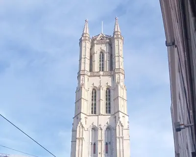 a tall white tower with a clock on it at STUDIO61 in Ghent