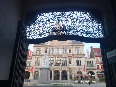a large building with a statue in front of it at STUDIO61 in Ghent