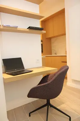 a laptop computer sitting on a desk with a chair at STUDIO61 in Ghent