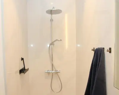 a shower with a shower head in a bathroom at STUDIO61 in Ghent