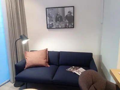a blue couch in a living room with a picture on the wall at STUDIO61 in Ghent