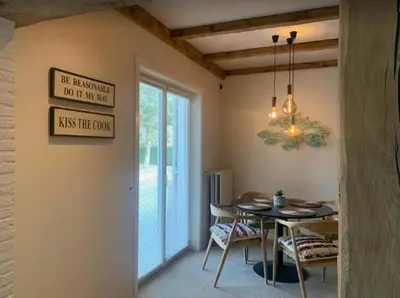 a dining room with a table and a chandelier at Casa57 in Waasmunster