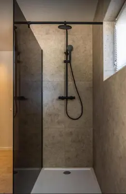 a shower with a glass door in a bathroom at Casa57 in Waasmunster