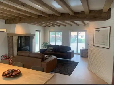 a living room with a couch and a table at Casa57 in Waasmunster