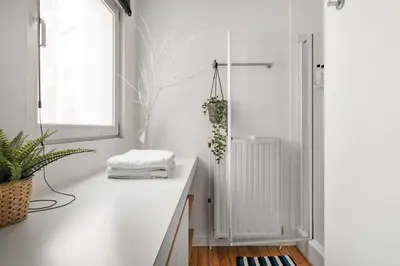 a white room with a white counter and a window at Family Townhouse in the City Centre in Ghent