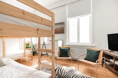 a bedroom with a bunk bed and a desk at Family Townhouse in the City Centre in Ghent