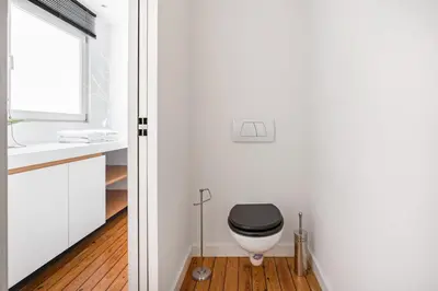 a bathroom with a toilet and a sink at Family Townhouse in the City Centre in Ghent