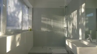 a bathroom with a sink and a toilet and a window at B&B Home & the City in Brussels