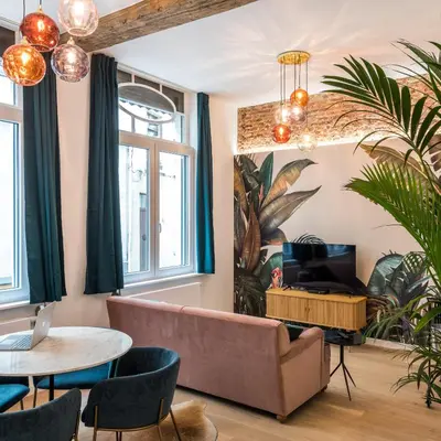 a living room with a couch and a table at Beautiful appartment in the heart of Antwerp in Antwerp