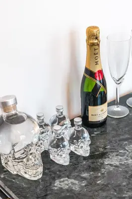 a bottle of wine and glasses on a table at Beautiful appartment in the heart of Antwerp in Antwerp