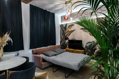 a living room with a couch and a table at Beautiful appartment in the heart of Antwerp in Antwerp