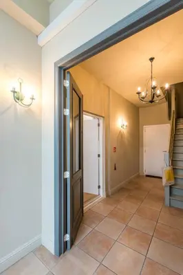 a hallway with a door leading to a stairway at Beautiful appartment in the heart of Antwerp in Antwerp