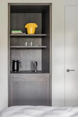 a cupboard with two pots and a bowl on it at Hotel Nenuphar in Ghent