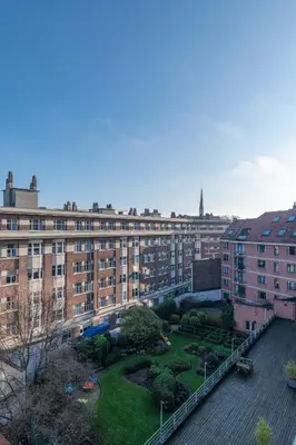 a large building with a garden in front of it at Royal Design Residence in Brussels